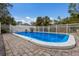 Private backyard swimming pool with a brick surround and safety fence for relaxing outdoor enjoyment at 500 N Jefferson Ave # G5, Sarasota, FL 34237