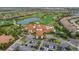 Aerial view of the clubhouse, golf course, and community amenities in a sprawling neighborhood at 5011 Tivoli Run, Bradenton, FL 34211