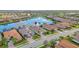 Aerial view of a home situated on a lake, surrounded by lush landscaping and other residences at 5011 Tivoli Run, Bradenton, FL 34211