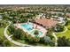 Aerial view of a community pool, clubhouse, and surrounding landscaping at 5011 Tivoli Run, Bradenton, FL 34211