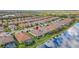 Expansive aerial view showcasing the home, neighborhood, and adjacent water feature at 5011 Tivoli Run, Bradenton, FL 34211