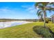 Scenic backyard featuring well-maintained lawn and serene lake backdrop at 5011 Tivoli Run, Bradenton, FL 34211