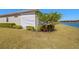 Well-maintained backyard with green lawn, lush landscaping, and views of the lake at 5011 Tivoli Run, Bradenton, FL 34211
