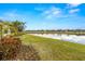 Beautifully landscaped backyard with lush green grass and tranquil lake view at 5011 Tivoli Run, Bradenton, FL 34211