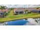 Expansive backyard view highlighting a screened lanai and picturesque waterfront at 5011 Tivoli Run, Bradenton, FL 34211
