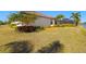 Spacious backyard with healthy green lawn, mature trees, and scenic lake view at 5011 Tivoli Run, Bradenton, FL 34211
