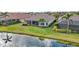 Lush backyard featuring a screened lanai with a beautiful lake view at 5011 Tivoli Run, Bradenton, FL 34211
