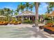 Outdoor restaurant and bar near a pool featuring lounge chairs and palm trees at 5011 Tivoli Run, Bradenton, FL 34211