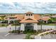 Exterior shot of the community clubhouse, showcasing its architecture and manicured grounds at 5011 Tivoli Run, Bradenton, FL 34211