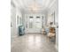 Bright foyer with a decorative light fixture, neutral walls, and an open floor plan at 5011 Tivoli Run, Bradenton, FL 34211
