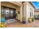 Inviting front porch with double glass doors, decorative plants, and a cozy seating area at 5011 Tivoli Run, Bradenton, FL 34211