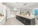 Gourmet kitchen with oversized center island, stainless steel appliances, and seamless transition to living areas at 5011 Tivoli Run, Bradenton, FL 34211
