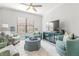 Inviting living room with plush seating and large windows providing natural light at 5011 Tivoli Run, Bradenton, FL 34211