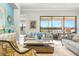 Cozy living room with comfortable seating, blue accents, and views of the backyard and lake at 5011 Tivoli Run, Bradenton, FL 34211