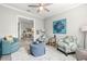 Cozy living room with designer seating and view into dining room at 5011 Tivoli Run, Bradenton, FL 34211