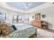 Bright main bedroom features a decorative ceiling, wood floors, and water views at 5011 Tivoli Run, Bradenton, FL 34211