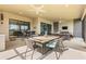 Large covered patio featuring an outdoor dining area and living space with lake views at 5011 Tivoli Run, Bradenton, FL 34211