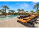 Luxury pool featuring lounge chairs and umbrellas and lush landscaping at 5011 Tivoli Run, Bradenton, FL 34211