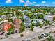 Aerial view of street, showing colorful homes with lush green landscaping and a well-maintained neighborhood at 5219 Calle Menorca, Sarasota, FL 34242