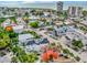 Panoramic aerial view of a vibrant coastal community with colorful homes, lush greenery, and ocean views at 5219 Calle Menorca, Sarasota, FL 34242