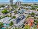 An aerial view of a neighborhood with colorful houses and views of the beach at 5219 Calle Menorca, Sarasota, FL 34242