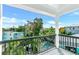 Balcony view overlooking lush landscaping, a pool, and surrounding homes at 5219 Calle Menorca, Sarasota, FL 34242