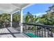 Balcony view overlooking the pool with a slide and tropical landscaping at 5219 Calle Menorca, Sarasota, FL 34242