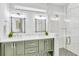 Modern bathroom with double sinks, subway tile, glass shower, and stylish lighting at 5219 Calle Menorca, Sarasota, FL 34242