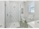 Beautiful bathroom features a glass shower, geometric tile, and a vanity with a sink at 5219 Calle Menorca, Sarasota, FL 34242