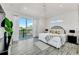 This bedroom features a large bed, access to a balcony, and neutral decor at 5219 Calle Menorca, Sarasota, FL 34242