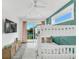 Relaxing bedroom featuring a bunk bed, large sliding glass doors leading to a balcony, and stylish décor at 5219 Calle Menorca, Sarasota, FL 34242