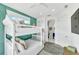 Bright bedroom features a white bunk bed, accent wall, and an ensuite bathroom for convenience at 5219 Calle Menorca, Sarasota, FL 34242