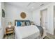 Bedroom with shiplap wall, ceiling fan, decorative mirror, queen bed, and ensuite bathroom at 5219 Calle Menorca, Sarasota, FL 34242