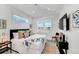 Bright bedroom features a bed, shiplap walls, lots of windows, and eclectic decor at 5219 Calle Menorca, Sarasota, FL 34242