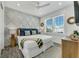 Bedroom with diamond patterned wall, queen bed, and lots of natural light through the windows at 5219 Calle Menorca, Sarasota, FL 34242