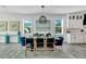 Formal dining room with modern decor, stylish lighting, and bright windows at 5219 Calle Menorca, Sarasota, FL 34242