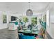 Open-concept dining area next to a living room with views of the outdoor area at 5219 Calle Menorca, Sarasota, FL 34242