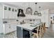 Bright kitchen with white cabinetry, stainless steel appliances, and a large center island at 5219 Calle Menorca, Sarasota, FL 34242