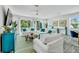 Spacious living room with comfortable white seating and access to an outdoor balcony at 5219 Calle Menorca, Sarasota, FL 34242