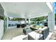 Expansive covered patio with comfortable seating, outdoor kitchen, and pool views at 5219 Calle Menorca, Sarasota, FL 34242