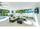 Comfortable outdoor patio featuring lounge seating, dining area, and grilling station by the pool at 5219 Calle Menorca, Sarasota, FL 34242