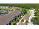 Aerial view showcases community's layout, with ponds, mature trees, and manicured landscaping at 5330 Hyland Hills Ave # 2324, Sarasota, FL 34241
