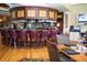 Well-appointed bar area with seating, drinks, and a view of the dining area at 5330 Hyland Hills Ave # 2324, Sarasota, FL 34241