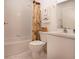 Well-maintained bathroom featuring a shower-tub combination and white tiled walls at 5330 Hyland Hills Ave # 2324, Sarasota, FL 34241