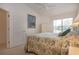Inviting bedroom featuring a calming tropical design, closet, and pleasant natural light at 5330 Hyland Hills Ave # 2324, Sarasota, FL 34241