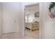 Condo entrance featuring an open door to a bedroom with a white coastal style bed at 5330 Hyland Hills Ave # 2324, Sarasota, FL 34241