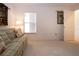 Bright, carpeted bedroom with window and a door leading to an adjacent room at 5330 Hyland Hills Ave # 2324, Sarasota, FL 34241