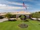 Aerial shot of the clubhouse entrance with a flagpole and meticulously maintained landscaping at 5330 Hyland Hills Ave # 2324, Sarasota, FL 34241