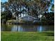 Welcoming entrance sign to Heritage Oaks Golf & Country Club surrounded by water and greenery at 5330 Hyland Hills Ave # 2324, Sarasota, FL 34241