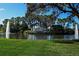 Scenic view of Heritage Oaks Golf & Country Club entrance with fountains and lush landscaping at 5330 Hyland Hills Ave # 2324, Sarasota, FL 34241